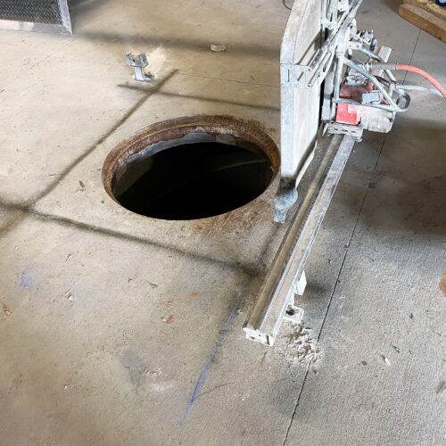 Image of a circular hole that has been sawed off on a concrete floor